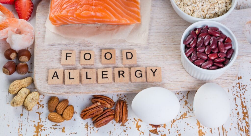Food Allergy spelled out in blocks surrounded by nuts, eggs, shellfish