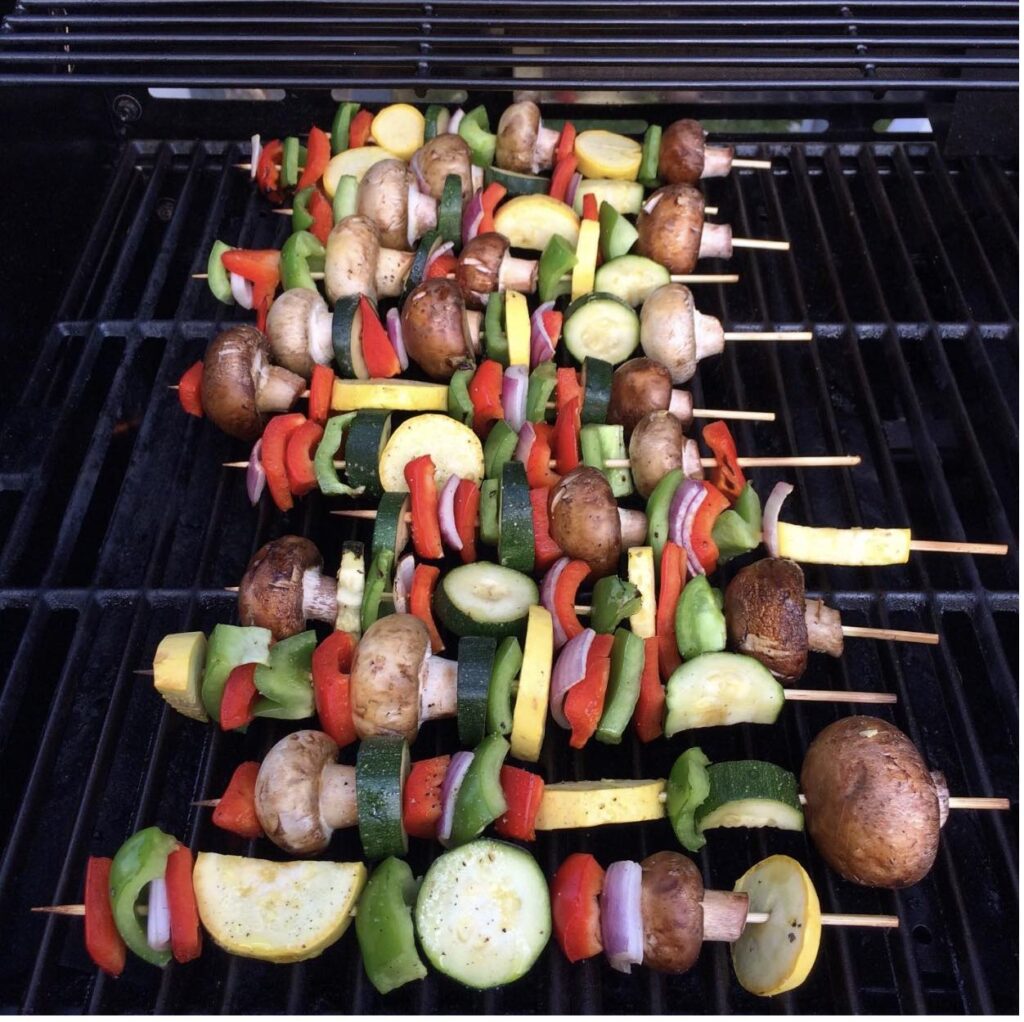 mixed vegetables on skewers on the grill. 